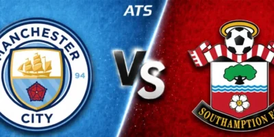 A wide, broadcast-style soccer matchup graphic split diagonally down the center. The left side features a blue textured background with the Manchester City crest prominently displayed, while the right side shows a red textured background with the Southampton FC crest. A bold “VS” sits in the middle along the dividing line, and “ATS” appears at the top center, giving it a polished sports media look.