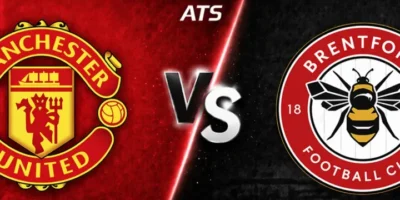 Wide split-screen match graphic showing Manchester United vs Brentford, with Manchester United’s crest on a red textured background on the left, Brentford’s crest on a dark striped background on the right, and a glowing “VS” divider with ATS branding in the center.