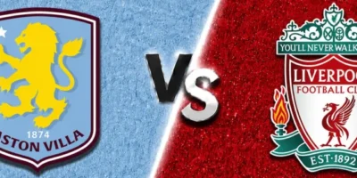 Aston Villa vs Liverpool match banner with both club crests on split light blue and red textured backgrounds, separated by a glowing diagonal line and a metallic VS graphic in the center.